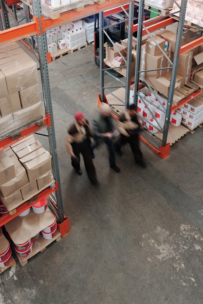 who-we-are Blurred motion of workers managing inventory in a warehouse.