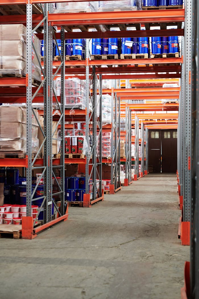 services-02 Industrial warehouse interior with organized shelves stacked with packages and goods.